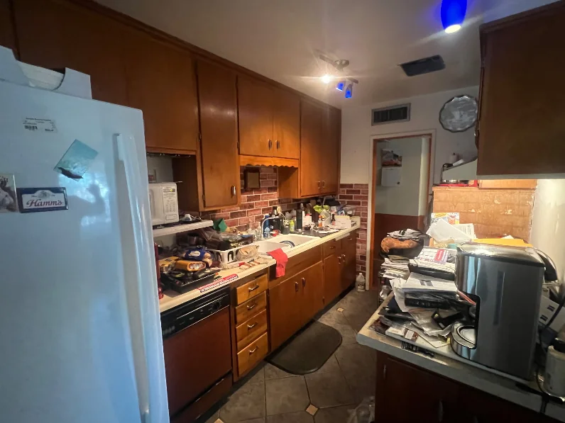 Before: dark wood galley kitchen