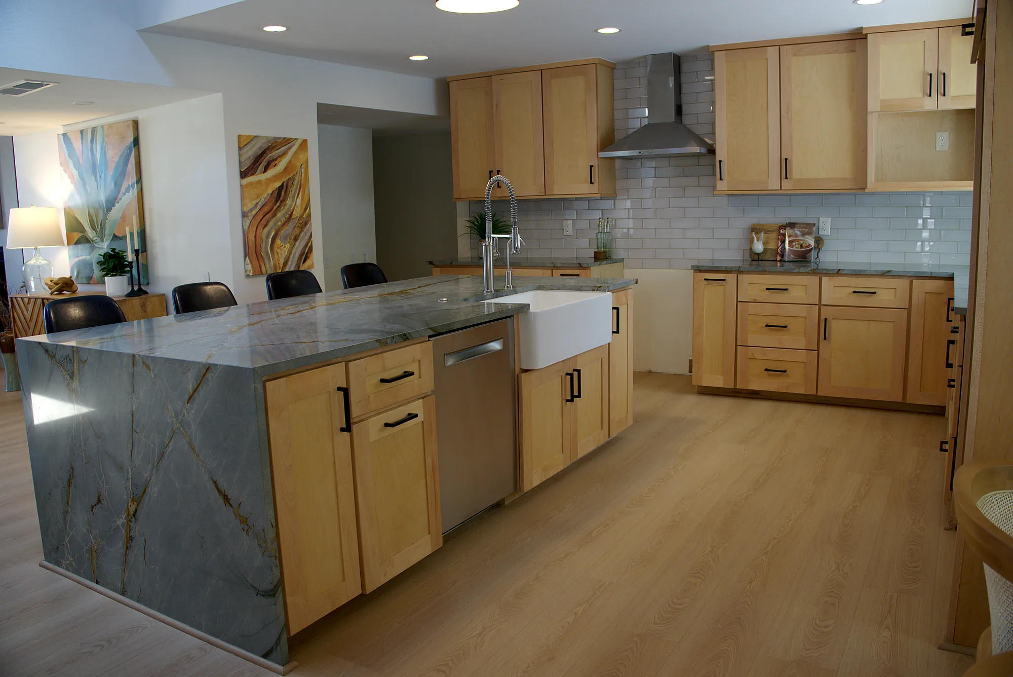 Finished kitchen with a waterfall island and light wood shaker cabinets on a Phoenix whole property job